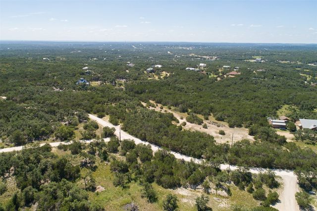 an aerial view of residential houses with city view