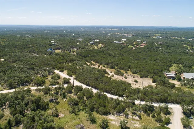 an aerial view of residential houses with city view
