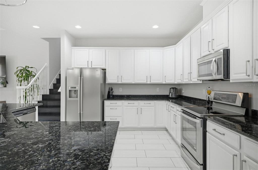 2914 Lee Shore Loop Orlando, FL 32820 - Photo 35 of 96 a kitchen with stainless steel appliances granite countertop a refrigerator sink and cabinets