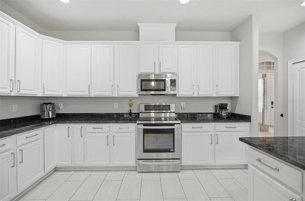 2914 Lee Shore Loop Orlando, FL 32820 - Photo 39 of 96 a kitchen with granite countertop white cabinets and appliances