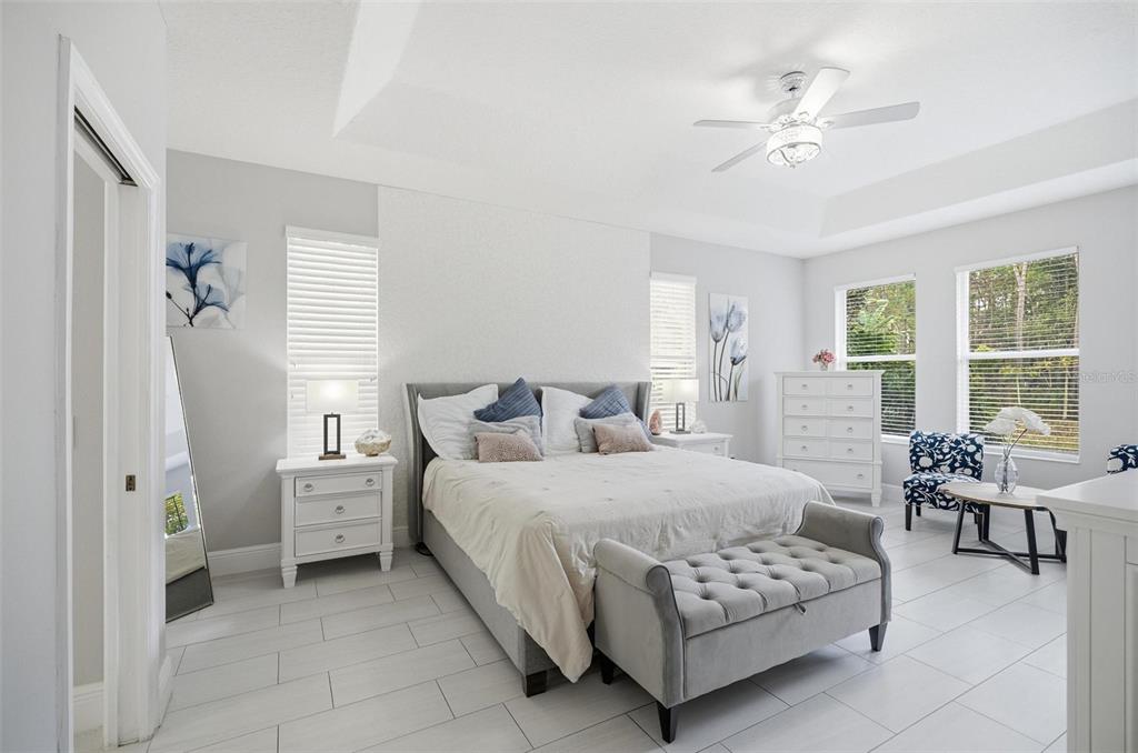 2914 Lee Shore Loop Orlando, FL 32820 - Photo 46 of 96 a bedroom with a bed a chandelier and a window