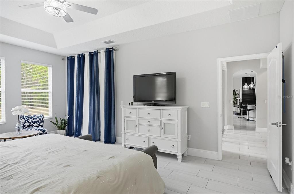 2914 Lee Shore Loop Orlando, FL 32820 - Photo 48 of 96 a bedroom with a bed and a flat screen tv