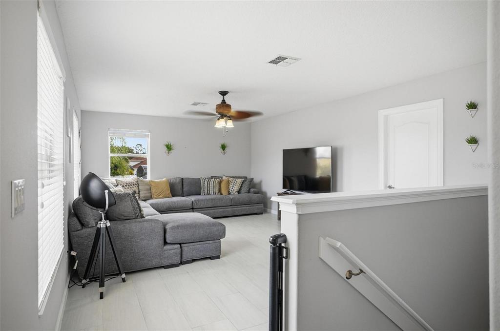 2914 Lee Shore Loop Orlando, FL 32820 - Photo 70 of 96 a living room with furniture and a flat screen tv