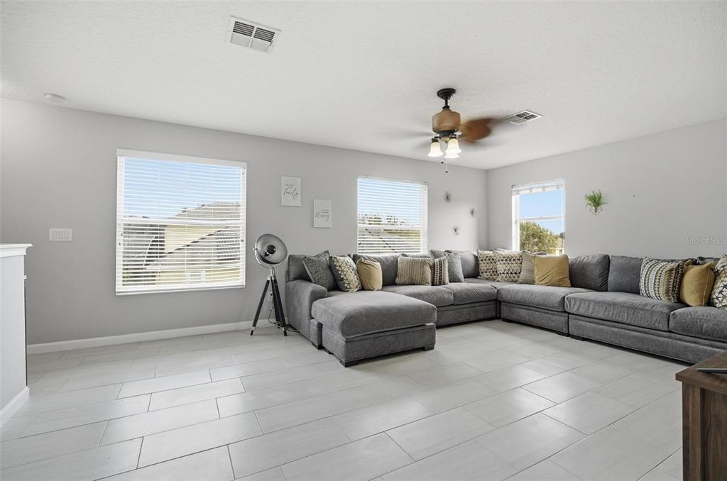 2914 Lee Shore Loop Orlando, FL 32820 - Photo 71 of 96 a living room with furniture a ceiling fan and a window