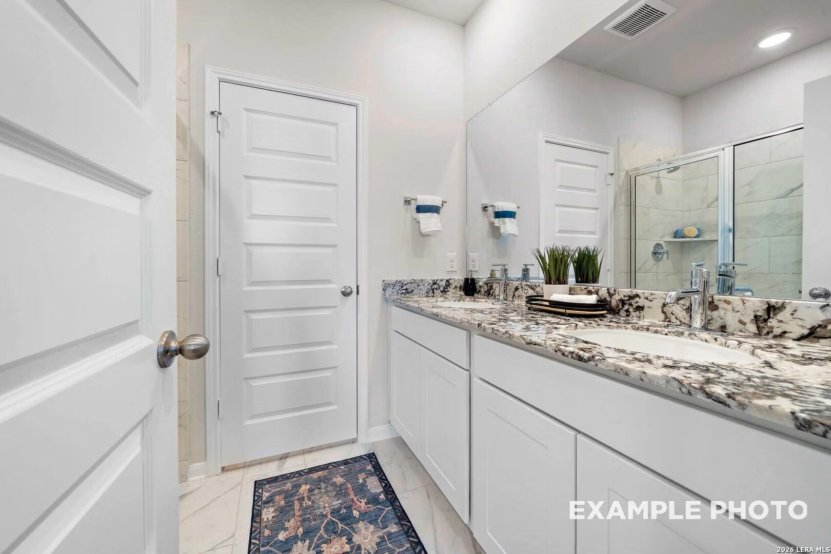 16611 Rosemary Ridge Elmendorf, TX 78112 - Photo 17 of 32 a bathroom with a granite countertop sink and a mirror