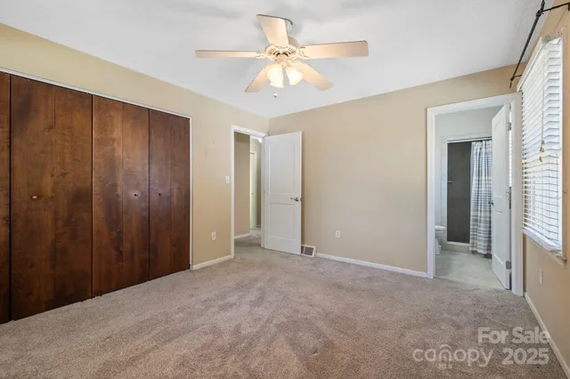 a view of an empty room with a ceiling fan