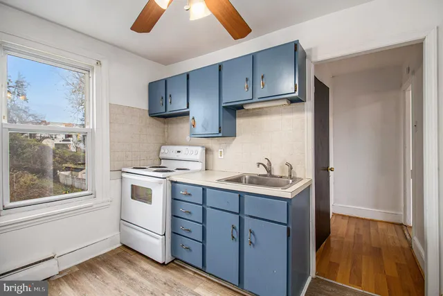 a kitchen with a sink cabinets and window