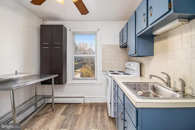 a kitchen with a sink a stove and cabinets