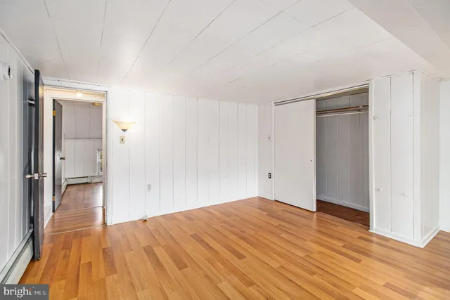 a view of an empty room with wooden floor
