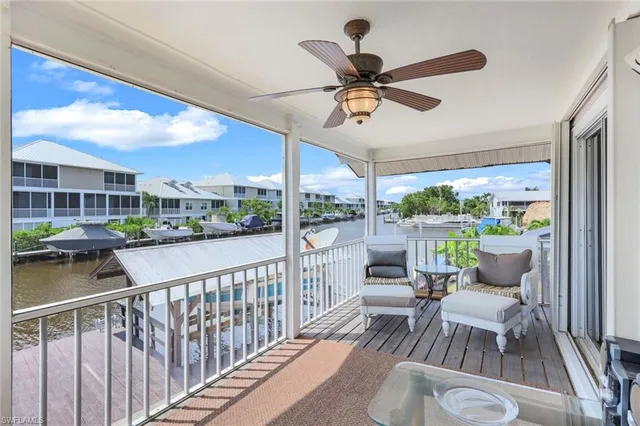 a view of a chair and tables in the balcony