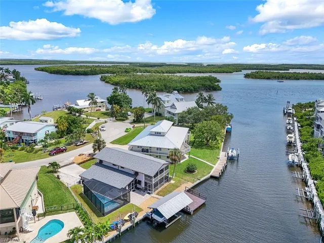 an aerial view of a house with outdoor space swimming pool and lake view
