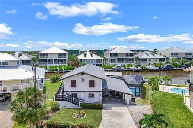 an aerial view of a house with a garden and lake view