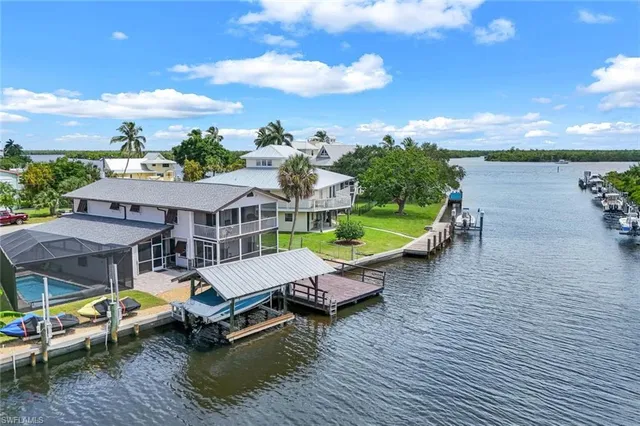 an aerial view of a house with swimming pool and patio