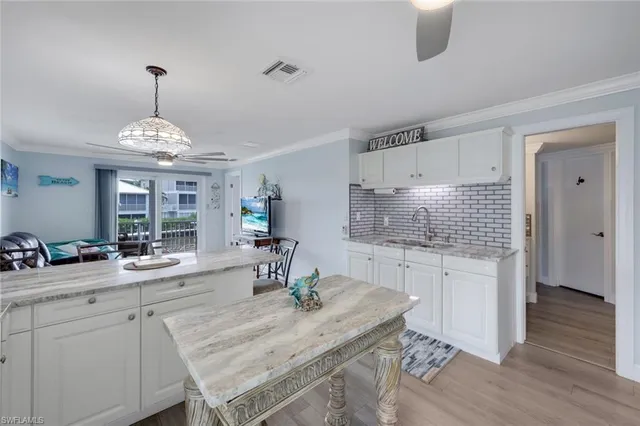 a kitchen with sink cabinets and wooden floor