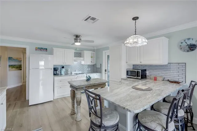 a view of kitchen and dining area with chandelier