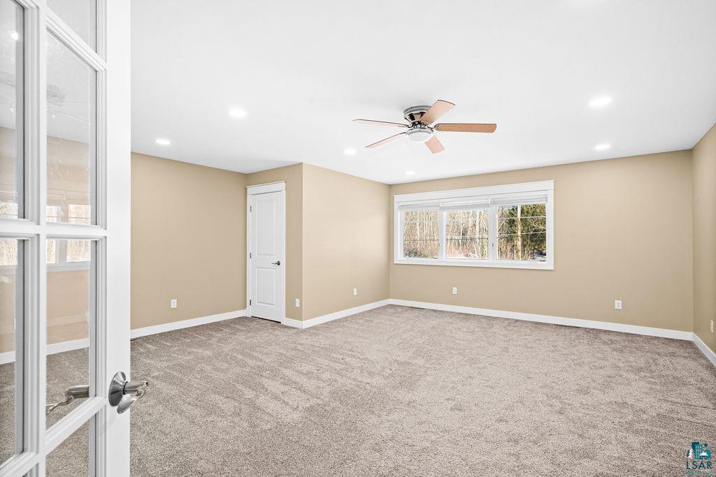 3879 Okerstrom Road Hermantown, MN 55811 - Photo 22 of 32 Empty room featuring light carpet, ceiling fan, and recessed lighting