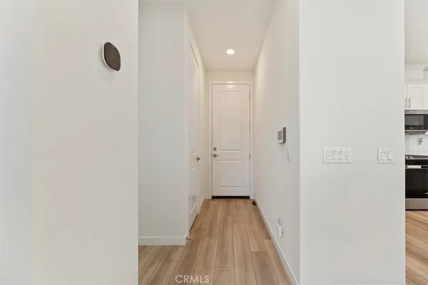 a view of a hallway with wooden floor