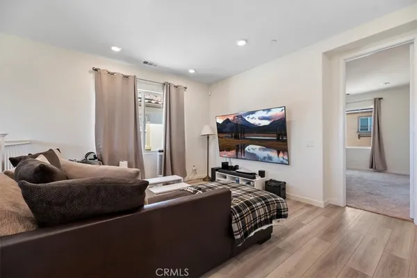 a bed room with furniture and a flat screen tv