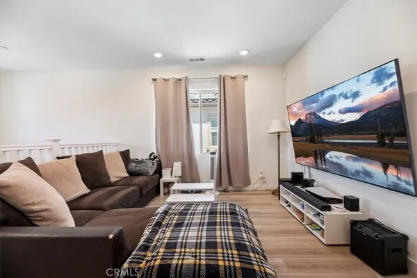 a bedroom with furniture and a flat screen tv