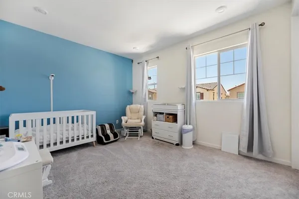 a bedroom with furniture and a window