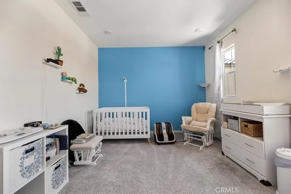 a bedroom with a bed and a chair