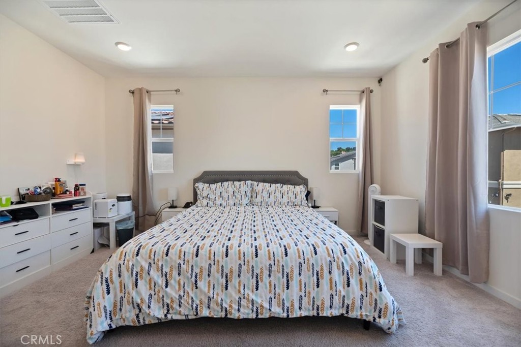 20911 Jennings Way Newhall, CA 91321 - Photo 37 of 50 a bedroom with a large bed and a chandelier