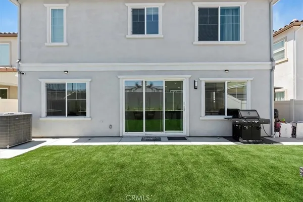 a view of a house with a yard and sitting area