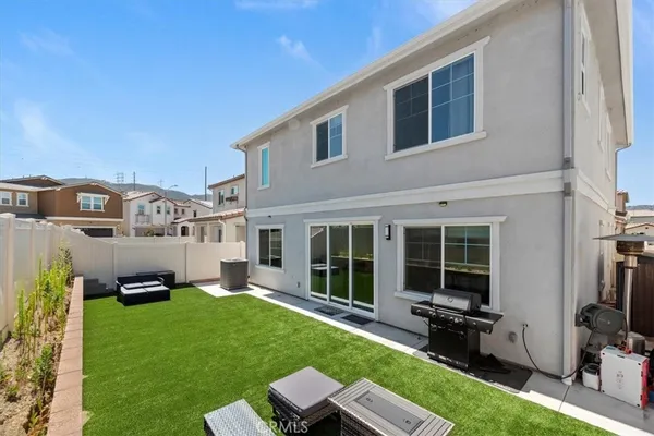 a backyard of a house with table and chairs
