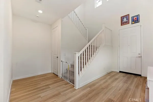 a view of a hallway with wooden floor and entryway