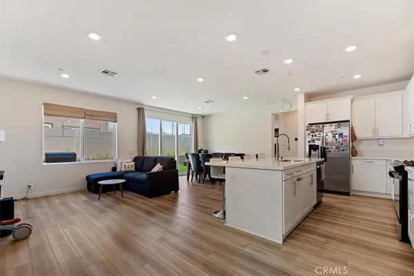 a large white kitchen with stainless steel appliances