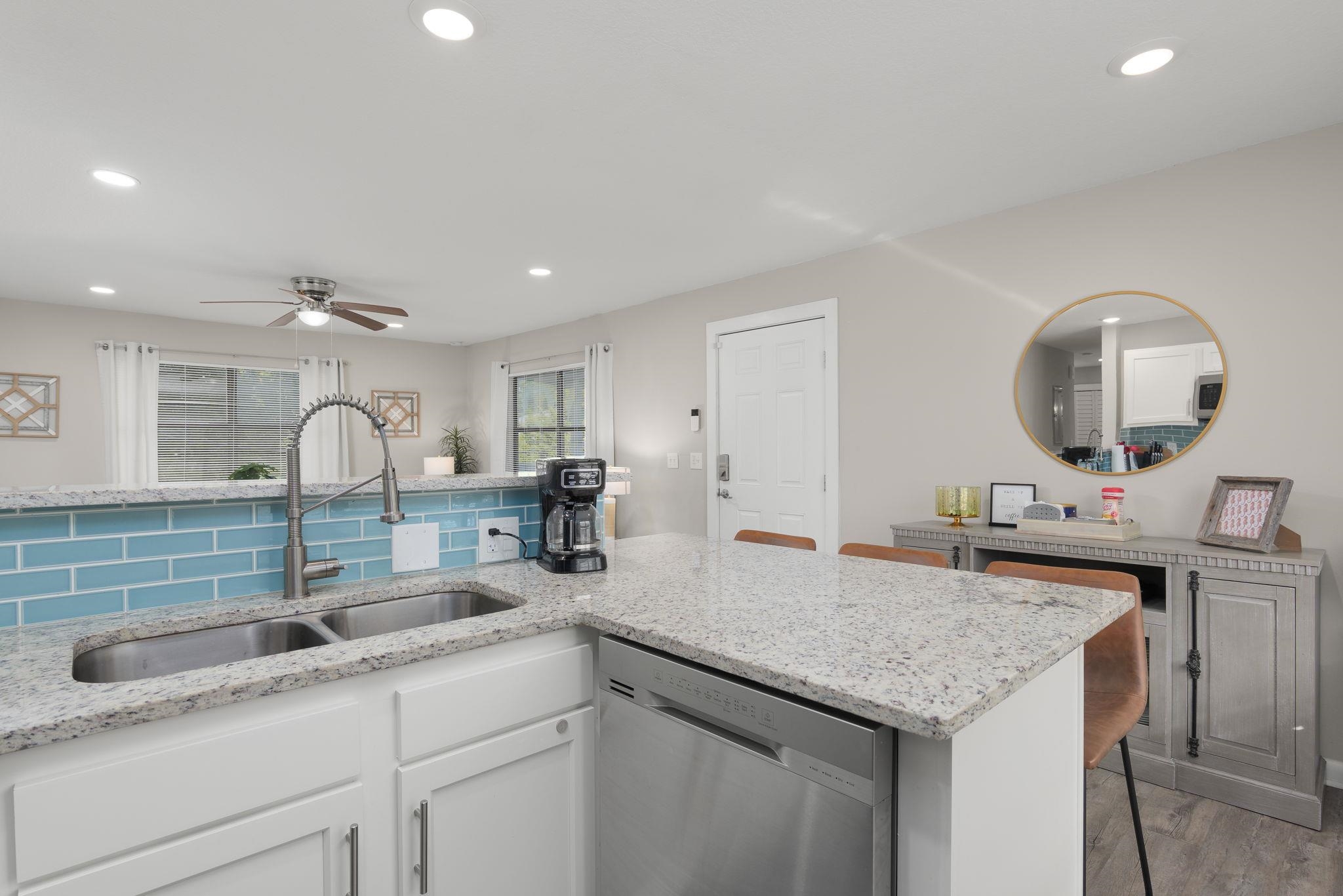 16 Ewing Street St. Augustine Beach, FL 32080 - Photo 18 of 55 a kitchen with a sink and a refrigerator
