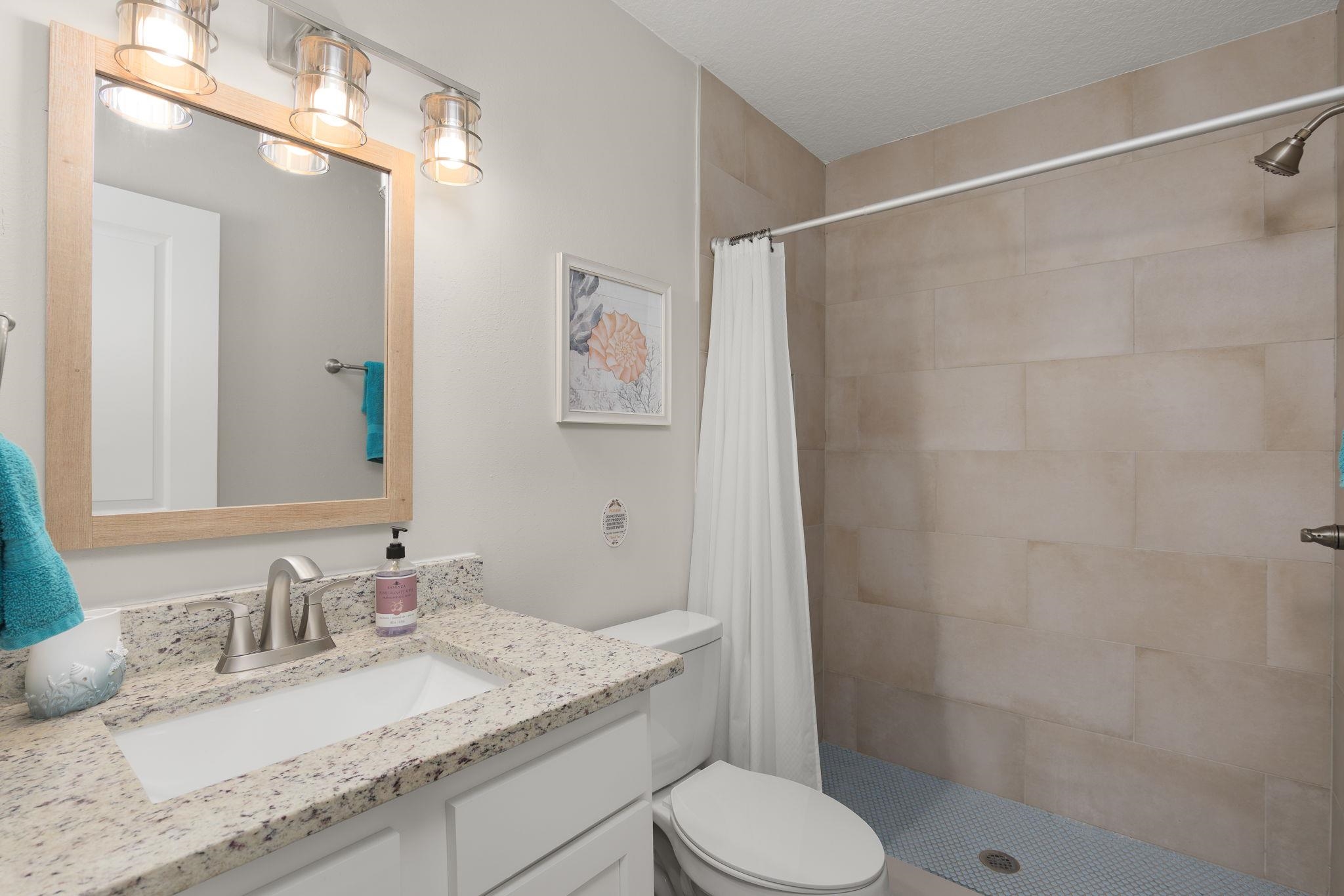 16 Ewing Street St. Augustine Beach, FL 32080 - Photo 45 of 55 a bathroom with a granite countertop sink toilet and shower