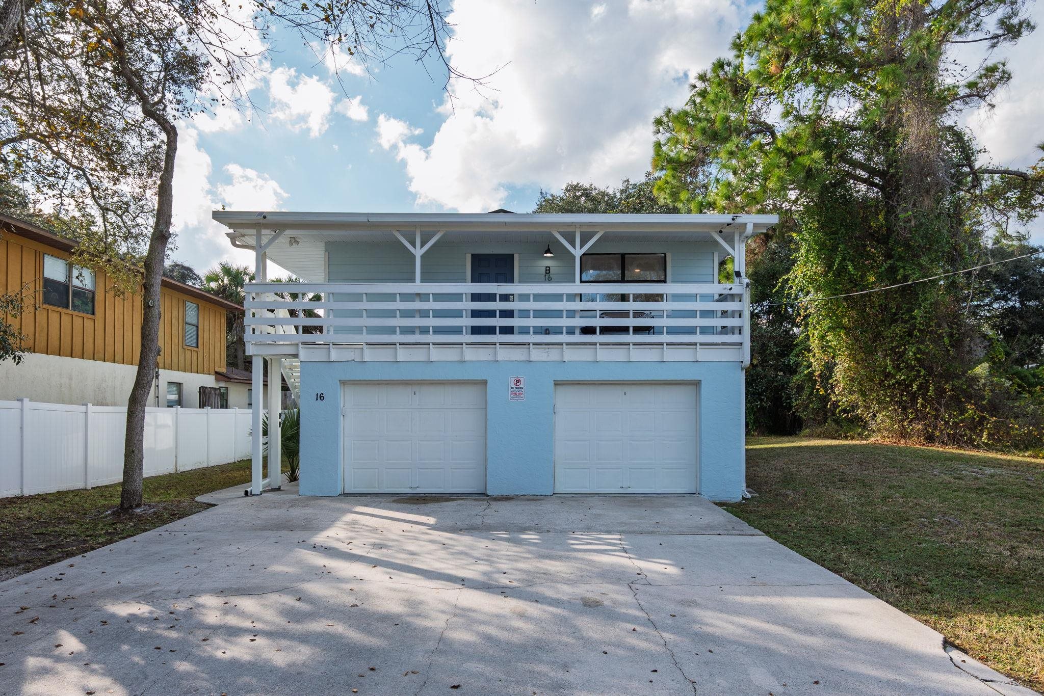 16 Ewing Street St. Augustine Beach, FL 32080 - Photo 51 of 55 a front view of a house with a yard and garage