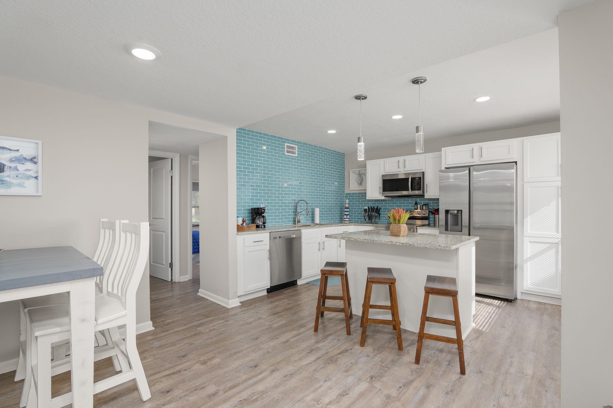 16 Ewing Street St. Augustine Beach, FL 32080 - Photo 8 of 55 a kitchen with stainless steel appliances a dining table chairs and wooden floor