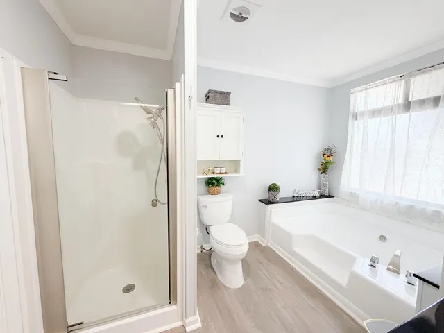 a white bath tub sitting next to a white toilet
