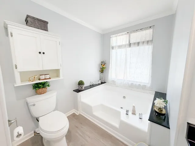 a bathroom with a sink toilet and window