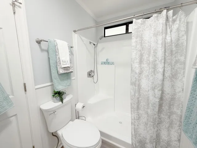a white toilet sitting next to a bathroom sink