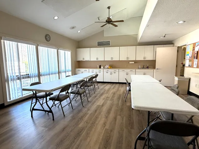 a large kitchen with a table and chairs in it
