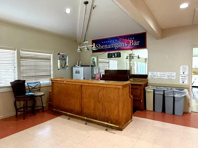 a kitchen with stainless steel appliances kitchen island granite countertop a stove top oven a sink dishwasher and a dining table with the kitchen view