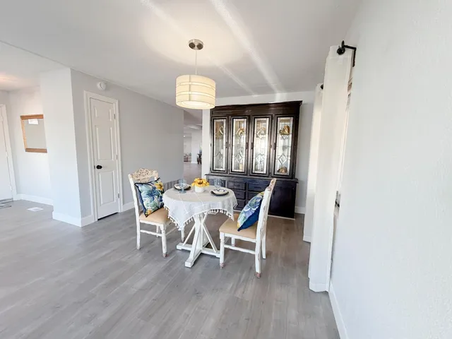 a view of a dining room with furniture and wooden floor
