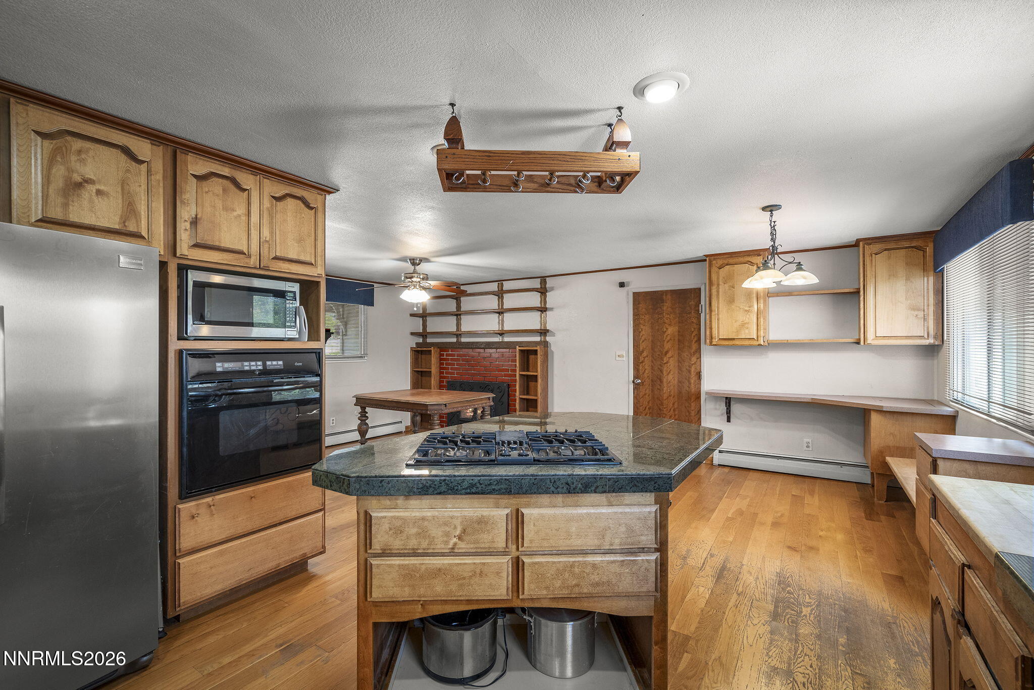 549 Ruby Lane Carson City, NV 89706 - Photo 7 of 37 a kitchen with granite countertop stainless steel appliances and wooden cabinets