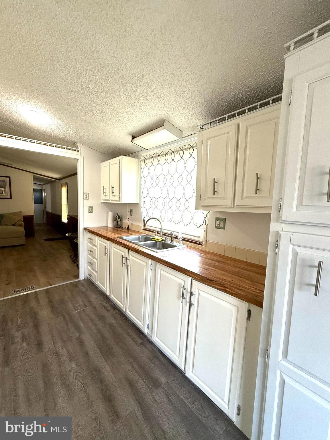 2908 Ram Road Cambridge, MD 21613 - Photo 15 of 27 a kitchen with granite countertop white cabinets and white appliances