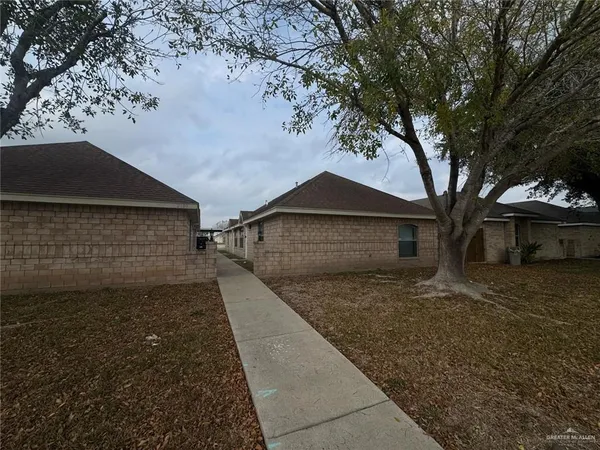 a front view of a house with trees