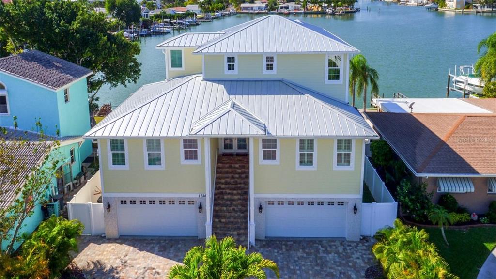 17340 Rosa Lee Way North Redington Beach, FL 33708 - Photo 1 of 1 a front view of a house with a garden