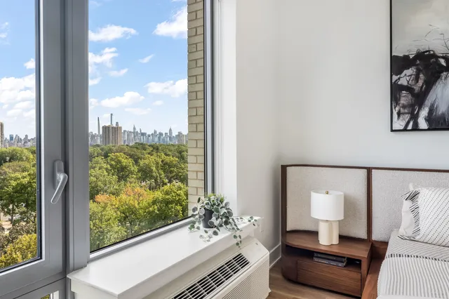 a room with a large window and couch