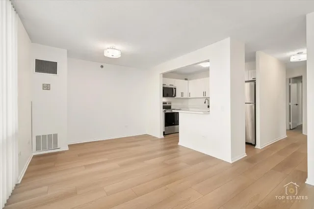 a kitchen with stainless steel appliances a refrigerator sink and cabinets
