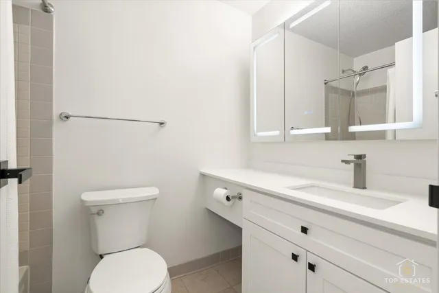 a white bath tub sitting next to a white toilet and a shower