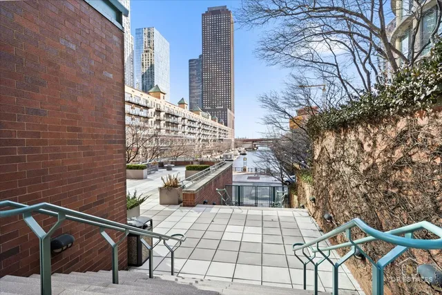 a view of a balcony with two chairs and a fire pit