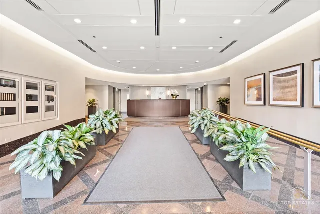 a lobby with furniture and a large mirror