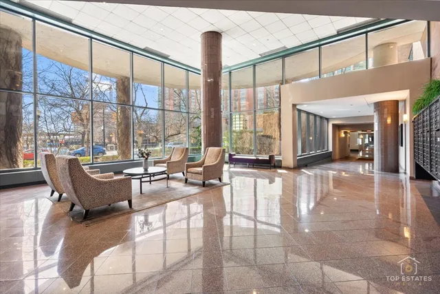 a living room with fireplace furniture and a large window